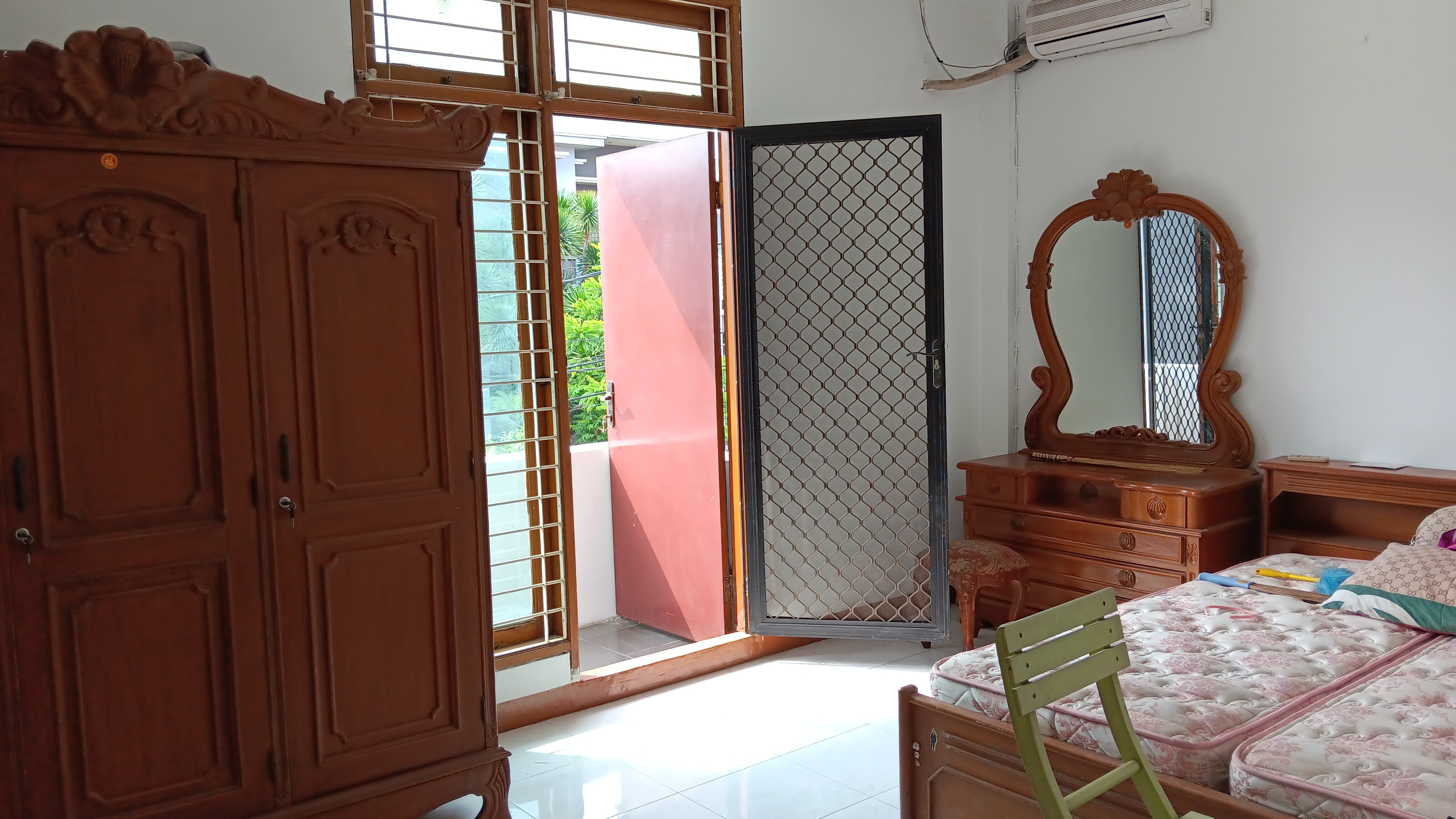 Master bedroom with balcony access and AC