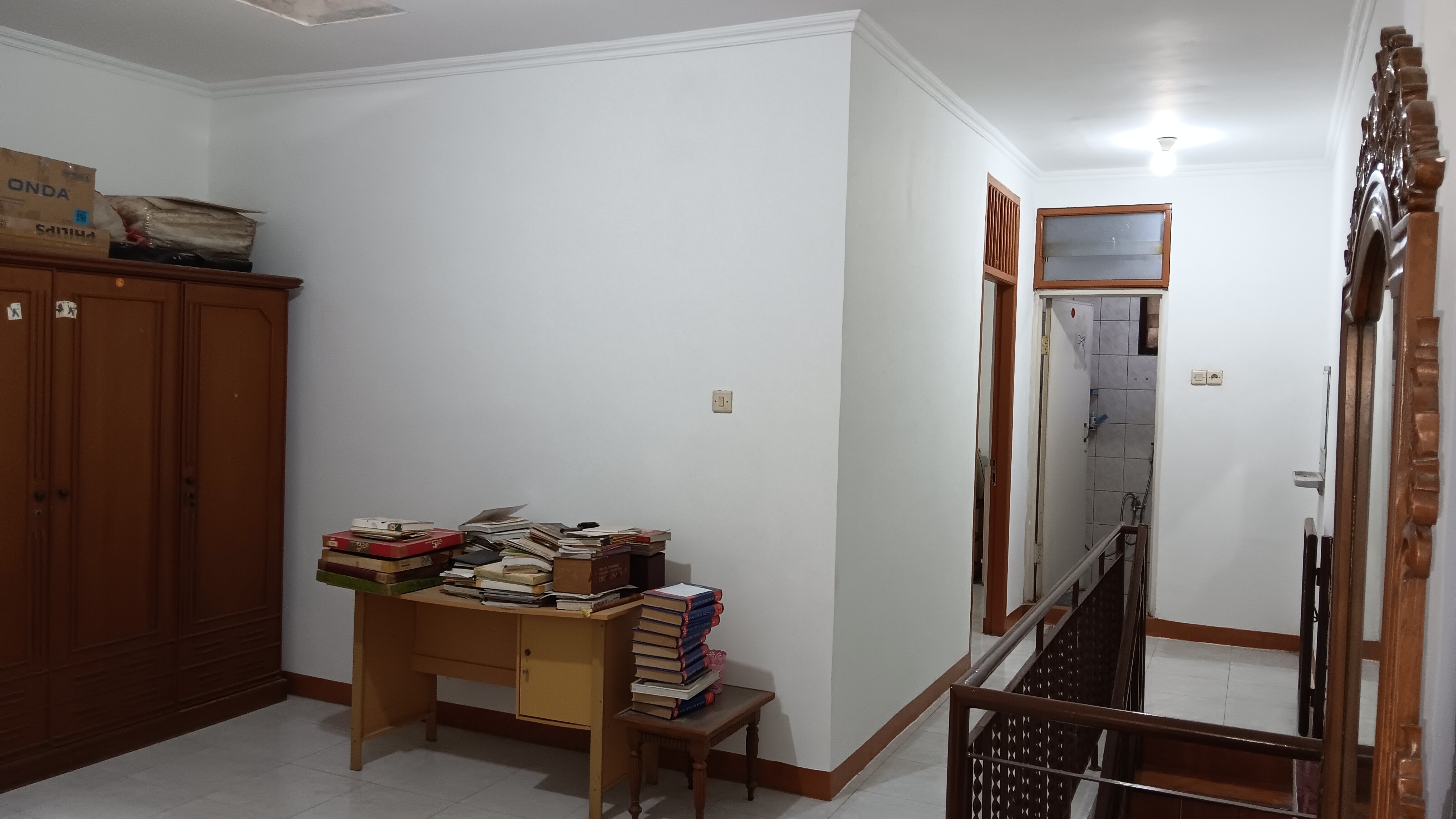 Space on second floor with stairs and bathroom corridor